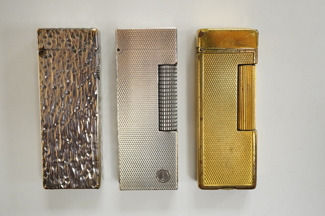Three assorted plated Dunhill lighters and a gilt example, largest 6.5cm high